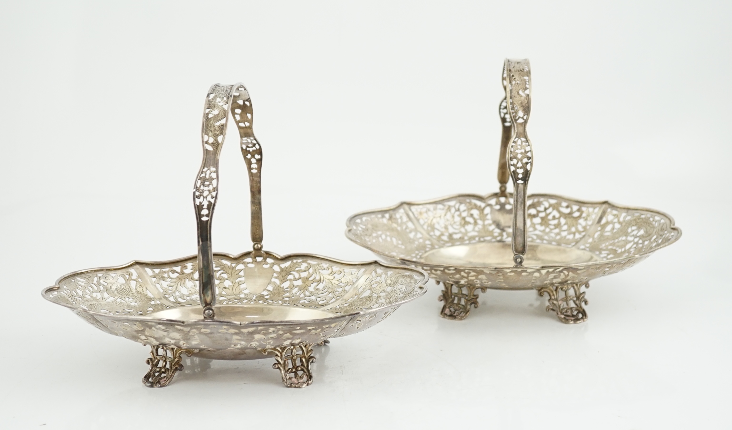 A pair of early 20th century Chinese Export pierced silver cake baskets, by Wang Hing, Hong Kong